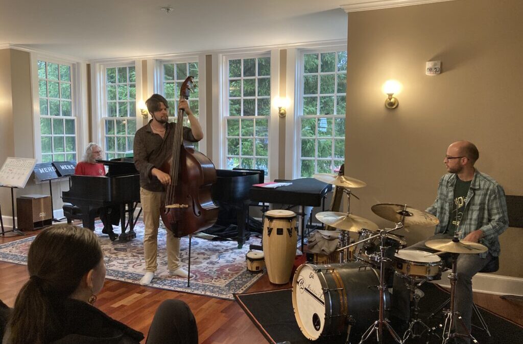 Jazz trio performing in a room.